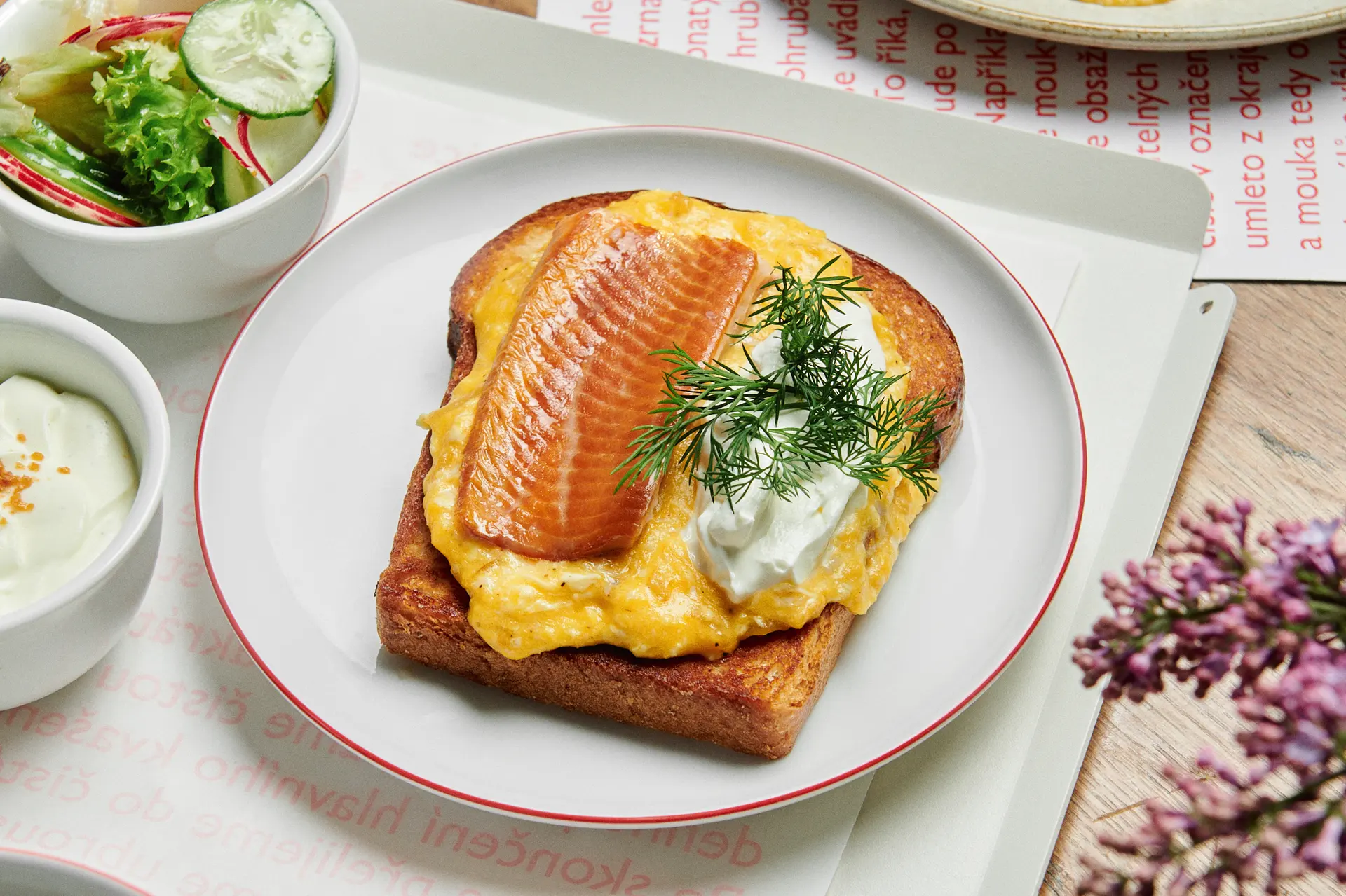 Sourdough toast with scrambled eggs, smoked salmon and dill.